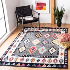 a living room with a chair and rug on the floor