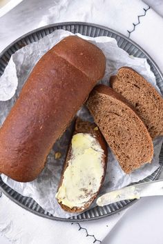 two loaves of bread on a plate with butter