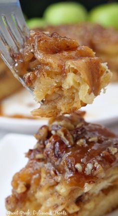 a fork is holding up a piece of apple pie