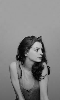 a black and white photo of a woman sitting down