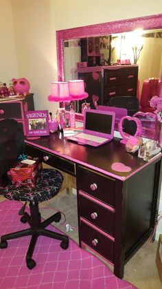 a desk with a laptop computer on top of it next to a chair and mirror