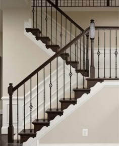 a stair case in an empty room with white walls