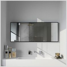 a bathroom with a large mirror above the sink