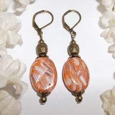 This Stunning Bohemian Beaded Earring Set Is Brand New & Handmade By Me. Done With Bumpy And Dented Mother Of Pearl White, Cream, Orange, And Brown Beads. The Pair Also Have Rustic Antiqued Bronze Toned Costume Jewelry Beads. They Dangle & Drop From Lever Backs For Women's Pierced Ears. 2 1/8 Inches Tall & 1/2 Inch Wide. Each Single Earring Weighs 3.7 Grams. You Will Absolutely Love The Color Combination On These. A Match Made In Heaven! Funky Unique Bold Dangly Dangling Bead Fashion Accessory H Elegant Orange Copper Earrings, Orange Beaded Vintage Earrings, Vintage Orange Beaded Earrings, Vintage Orange Earrings For Gift, Orange Vintage Earrings For Gift, Nickel Free Orange Jewelry For Party, Nickel Free Copper Orange Earrings, Handmade Orange Copper Earrings, Nickel-free Orange Jewelry For Party