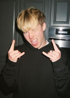 a young man making the vulcan sign with his hands