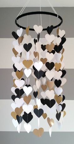 a heart mobile hanging from the ceiling in a room with striped walls and flooring