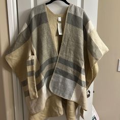 Bought From Francescas Color Is Beige, Gray, White One Size Fits All Super Comfy Material Ties In Front Definitely Have To Wear Something Underneath Because Sides Are Open Fast Shipping And From A Smoke Free Home! Oversized Long Sleeve Beige Cape, Casual Oversized Cream Poncho, White Oversized Winter Cape, Oversized Casual Beige Poncho, Casual Oversized Beige Poncho, Oversized White Cape Outerwear, White Long Sleeve Cape For Fall, Oversized Long Sleeve Cream Poncho, Cream Oversized Long Sleeve Poncho