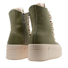 The sneakers are high-top platform-style shoes with a dominant color scheme of green and cream laces. They feature a thick, cream-colored rubber sole with layered detailing that gives the shoe a bold and chunky silhouette. Cream Lace, Color Scheme, Cream Color, High Top, High Tops, Rubber Sole, Color Schemes, Fashion Shoes, Cream