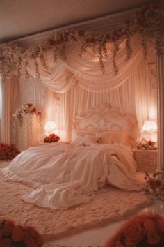 a bed with white sheets and flowers on the headboard is surrounded by curtains, lights, and pillows