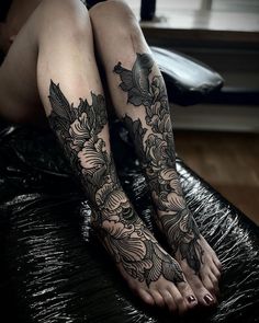 a woman's legs with tattoos on them