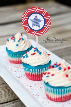 red, white and blue cupcakes on a plate with a flag topper