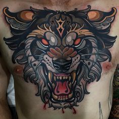 a man with tattoos on his chest has a tiger tattoo on it's chest