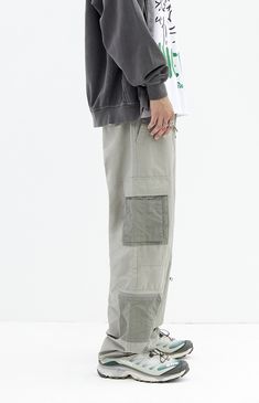 The Shadow Baggy Cargo Pants from PacSun offer a relaxed fit with wide legs, crafted from a durable cotton-nylon blend. Featuring a drawstring waistline, reinforced seams, side entry pockets, and cargo pockets with zipper details, these pants seamlessly blend practicality with contemporary style.


	Drawstring waistline
	Side pockets
	Welt back pockets
	Relaxed fit
	Cargo pockets with zip detail
	30" Inseam
	19.5" Leg opening
	Rigid
	66% Cotton, 34% nylon
	Machine washable
	Measurements taken from a size medium
	Model is wearing size medium
	Model Measurements: 6'2” Height, 30” Waist, 32” Inseam Urban Parachute Pants With Patch Pockets, Streetwear Full-length Parachute Pants With Patch Pockets, Streetwear Parachute Pants With Patch Pockets, Streetwear Full Length Parachute Pants With Patch Pockets, Full Length Parachute Pants With Patch Pockets For Streetwear, Cotton Drawstring Full-length Pants, Full Length Cotton Pants With Drawstring, Urban Parachute Pants With Patch Pockets For Outdoors, Cotton Techwear Sweatpants For Outdoor