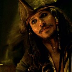 a man in a pirate costume with long hair and a cat's eye patch on his forehead