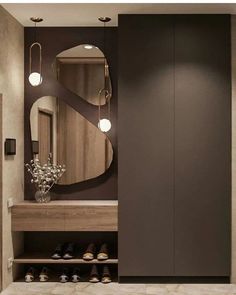 a bathroom with a mirror and some shoes on the floor