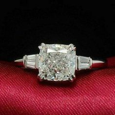 a cushion cut diamond ring with baguettes on the sides