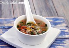 a white bowl filled with soup on top of a table