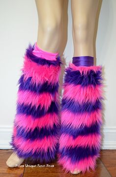 the legs of a mannequin wearing purple and pink furry boots with stripes on them