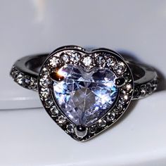 This Stunning Heart Shape Ring Has A Beautiful Sparkly Clear Genuine Crystal And It’s A Size 7, Brand New. Make’s The Perfect Promise Ring For The Upcoming Holidays. Heart Cut Rings With Diamond Accents, Cubic Zirconia Heart Ring With Vs Clarity, Heart Shaped Jewelry With Halo Setting, Double Heart Ring For Valentine's Day, Classic Silver Heart Ring With Halo Setting, Elegant Heart Ring Stamped 925, Elegant Stamped 925 Heart Ring, Elegant Heart Ring With Heart Charm, Heart Charm Promise Ring