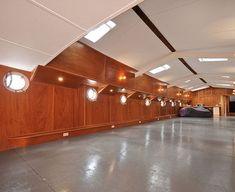 an empty room with wood paneling and round lights on the ceiling is pictured in this image