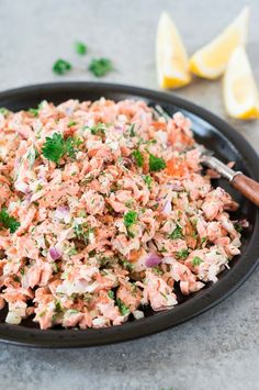 a black bowl filled with food and garnished with parsley on the side