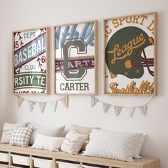 three framed sports posters hang on the wall above a bench with pillows and throw pillows