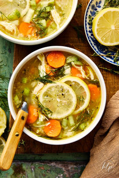 two bowls of soup with lemons, carrots and celery