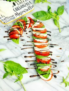 lobster and avocado skewers on a marble platter with basil leaves