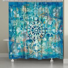 a blue shower curtain with an abstract design on the front and back side, in a bathroom