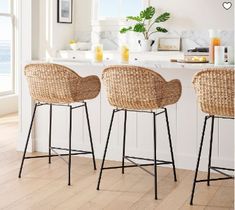 two wicker bar stools in front of a kitchen island