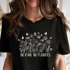 This inspirational quote Wildflower No Rain No Flowers Graphic tee would make the perfect gift for the nature lover in your life.  Comes in multiple colors! ❤️ Our Unisex T-shirts are High Quality, SUPER soft and SUPER comfy. They are made of 100% Cotton. Heather tees are a soft cotton-poly blend. This listing is for our BELLA+CANVAS T-shirts! We also carry Gildan and Comfort Colors T-shirts, if you would prefer one of those just message us and we would be happy to accommodate! ❤️ ✨️MADE TO ORDE Inspirational Letter Print T-shirt For Spring, Plants Print Crew Neck T-shirt Gift, Plants Print Crew Neck T-shirt For Gift, Crew Neck T-shirt With Plants Print, Inspirational Letter Print Top As Gift, Inspirational Slogan T-shirt For Spring, Inspirational T-shirt With Letter Print As Gift, Spring Letter Print T-shirt Gift, Spring Text Print Top As Gift