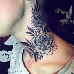 a woman's neck with flowers and leaves on it