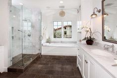 a large bathroom with two sinks and a walk in shower next to a bathtub