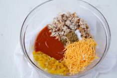 the ingredients to make an enchilada in a glass bowl on a white surface