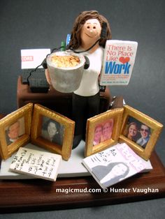 a figurine holding a bowl of food on top of a table with pictures