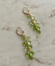 These are peridot drop earrings using 9 pear shaped stones in each, and wire wrapped with 14 k gold filled. They hang about 2.25 inches and are really easy to put on, using a lever back closure. Great the for the up coming holidays, great for gifts and great for evening wear. Not too long, not too short, they're just right. peridot drop earrings peridot and gold dangling earrings holiday earrings August birthstone earrings Peridot Dangle Earrings In Gold, Green Peridot Dangle Earrings, Peridot Dangle Earrings For May Birthstone, Green 14k Gold-filled Dangle Earrings, Green 14k Gold Filled Dangle Earrings, Gold Teardrop Peridot Earrings, Green Teardrop 14k Gold Filled Earrings, Green Peridot Teardrop Earrings, Peridot Dangle Earrings With Ear Wire