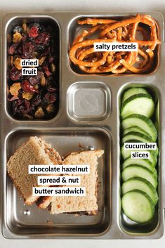 an image of a school lunch with pretzels, crackers and cranberries