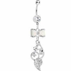 a white belly ring with crystal stones on the bottom and a bow at the top