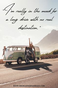 two people standing on the back of an old vw bus