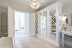 a bathroom with white walls and wooden floors