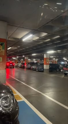 an empty parking garage with cars parked in the space between it and another car on the other side