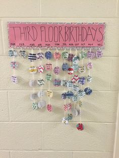 a birthday card hanging on a wall with buttons and magnets attached to the board