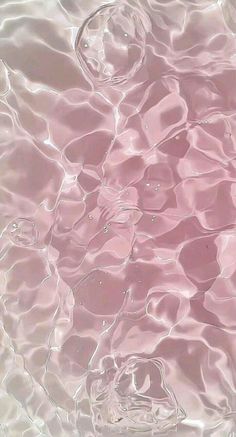 the water is pink and clear as it looks like ripples or bubbles in the water