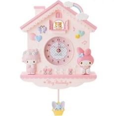 a pink clock with hello kitty on it