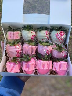 a box filled with chocolate covered strawberries in the shape of heart shaped letters and flowers