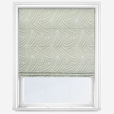 a roman blind with a green leaf pattern on the top and bottom, in front of a white window