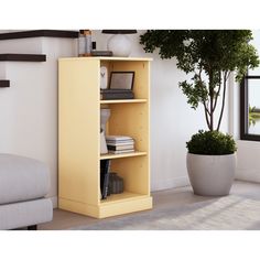 a yellow bookcase in the corner of a room with a potted plant on it