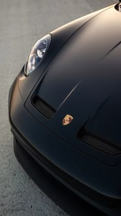 the front end of a black sports car