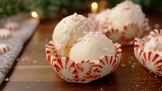 someone is spooning ice cream out of a red and white bowl with candy canes