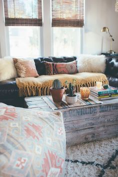 a living room filled with furniture and lots of pillows on top of the couches